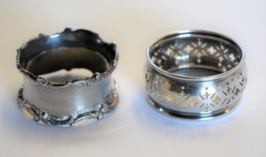 TWO SILVER NAPKIN RINGS: Both monogrammed, one with open cut work, marked sterling. Diam. 1 1/2"