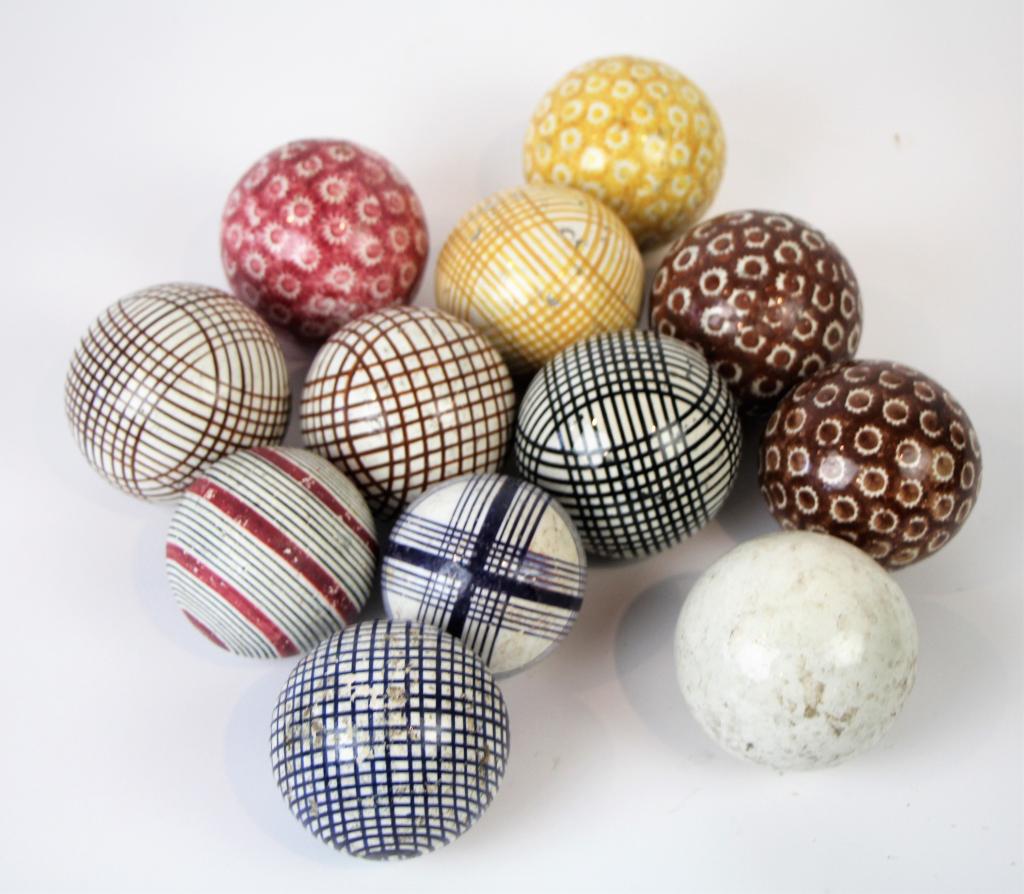 LOT OF CARPET BALLS: 12 in total, with white ball. Some striped and spongeware decoration. Minor wear but overall good condition. Diam: 3 1/4"