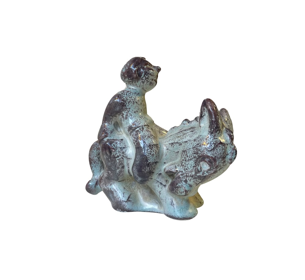 Ceramic Boy on Donkey Figurine from Michael Andersen & Son, 1950s: Rare Michael Anderssen ceramic figurine executed with Persia glaze. It depicts a boy on a donkey and is probably an Allegory of either laciness, stubbornness, being horny etc. It is marked with the cr