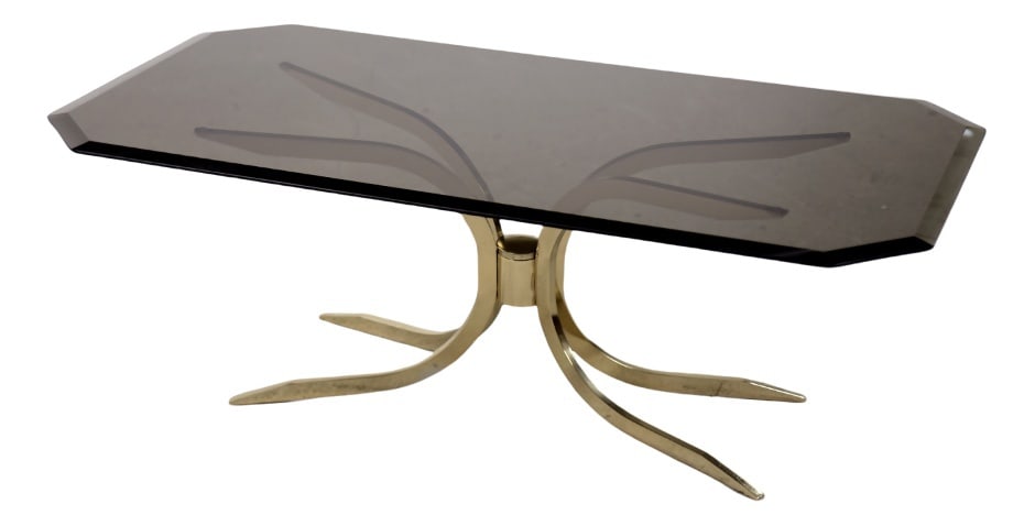 Vintage Regency Coffee Table With Glass Top, 1970s: This coffee table was produced during the 1970s. The base is made of four shiny, brass legs that have a raw, sharp form. The octagonal top is made of dark smoked glass, milled around. A piece of