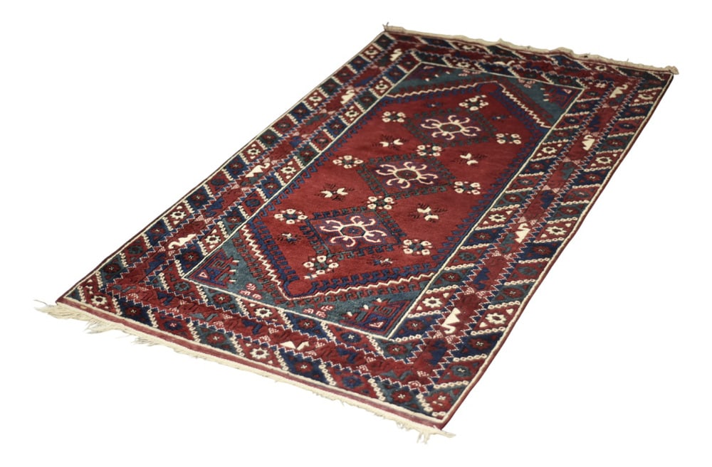 Vintage Red Hand-Woven Oriental Afghan Rug, 1970s: This oriental Afghan rug was made in Afghanistan during the 1970s. This rug is dyed in shades of red and turquoise. It is known worldwide for its high quality, durability and distinctive design.