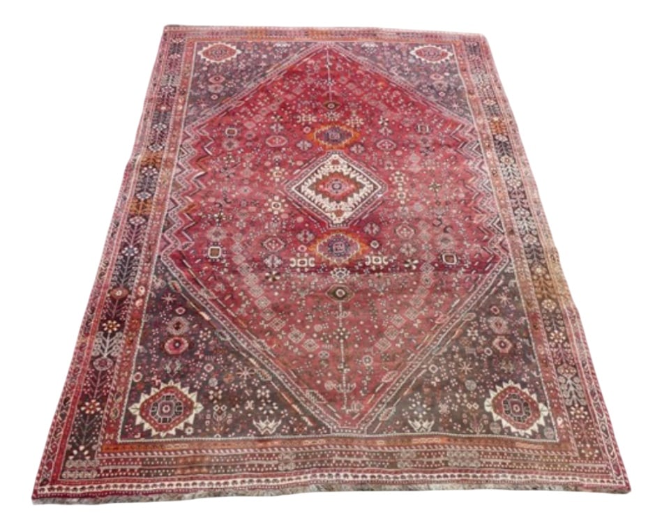 Large Antique Middle Eastern Qashqai Rug: This is a hand woven wool rug and is consistent with tribal or village-made rugs from regions like Shiraz or Khamseh in Persia. The rug features a central diamond motif, common in Shiraz carpets, and