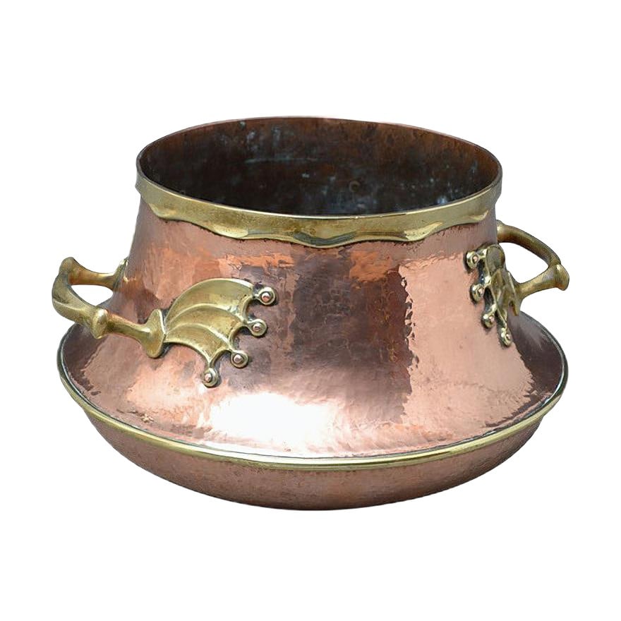 Large Victorian Copper and Brass Vessel: Outstanding 19th century copper and brass vessel of large proportions, having brass collar and substantial brass handles with bat or dragon wing motifs. This antique vessel would make a good planter