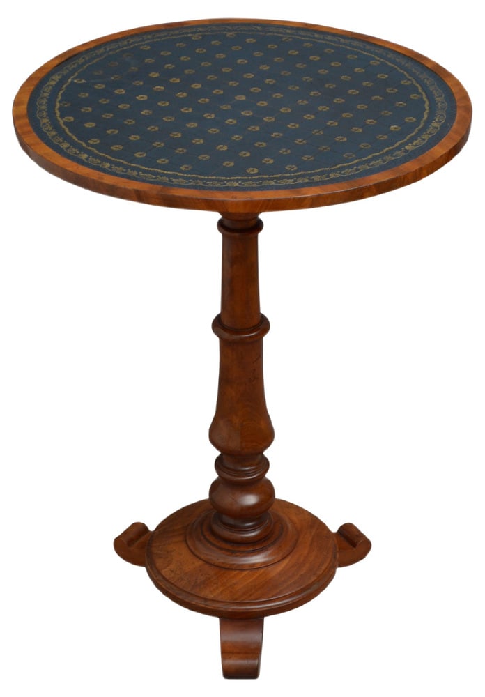 William IV Mahogany Occasional Table: Fine quality mahogany lamp or occasional table, having tooled leather circular top raised on slander turned and carved column terminating in circular moulded base and 3 shaped feet. This antique