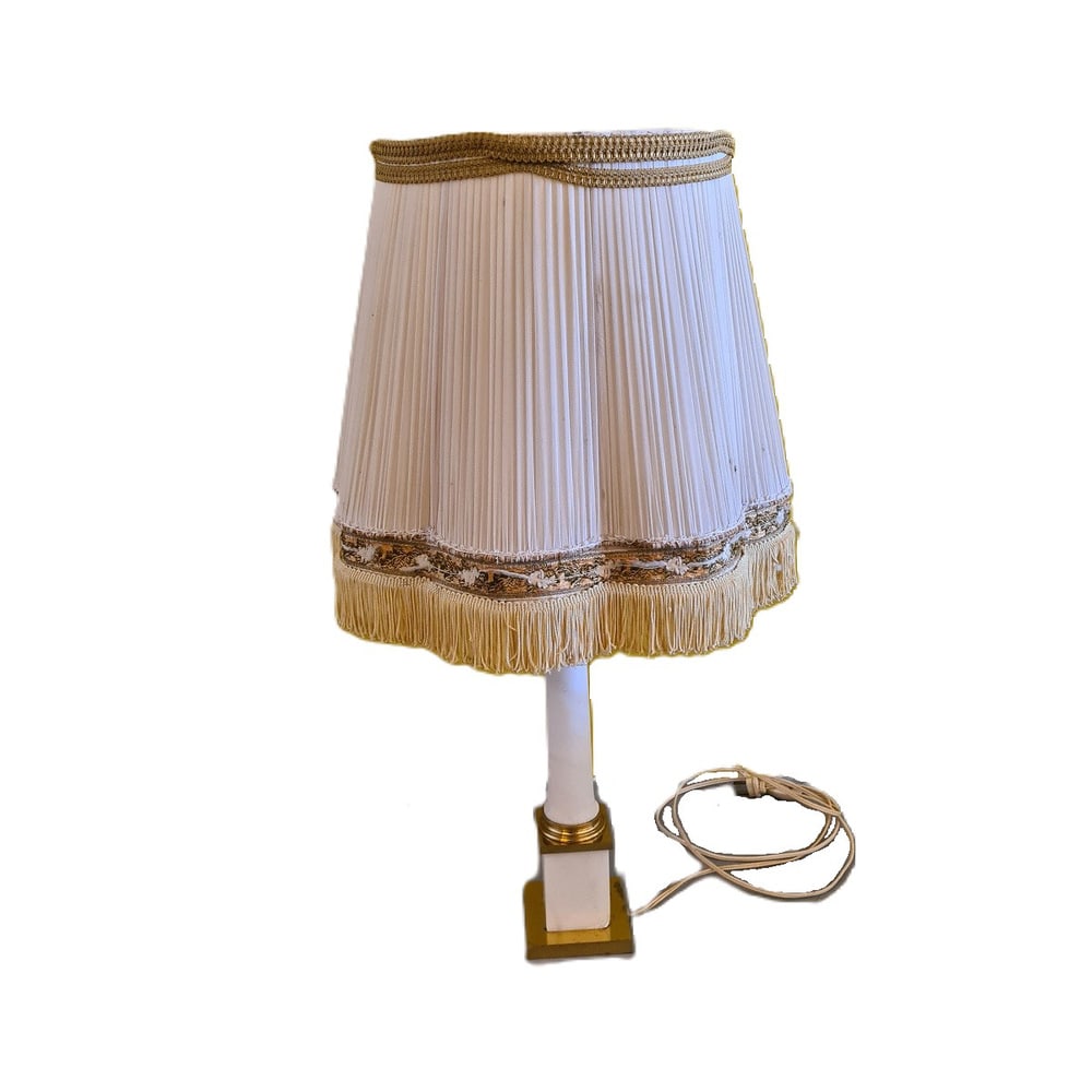 French Table Lamp, 1950s: Classic French table lamp with gilded elements and alabaster trunk. The hood is not very neat anymore and decorations were added later. The lower alabaster block has a small piece missing at 1