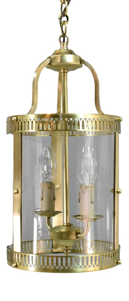 French Hall Lantern in Brass, 1890s: An attractive round hall lantern featuring pierced brass continuous rings at the top and bottom that hold three curved clear glass panels in the centre. Descending from the polished ceiling rose