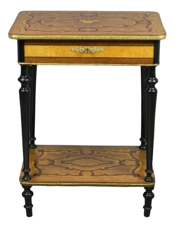 Antique French Marquetry Work Table: - Beautifully decorated marquetry work table featuring a floral motif to the central panel- The hinged top and lower shelf are banded with brass- Beneath the hinged top is a segmented storage area wit