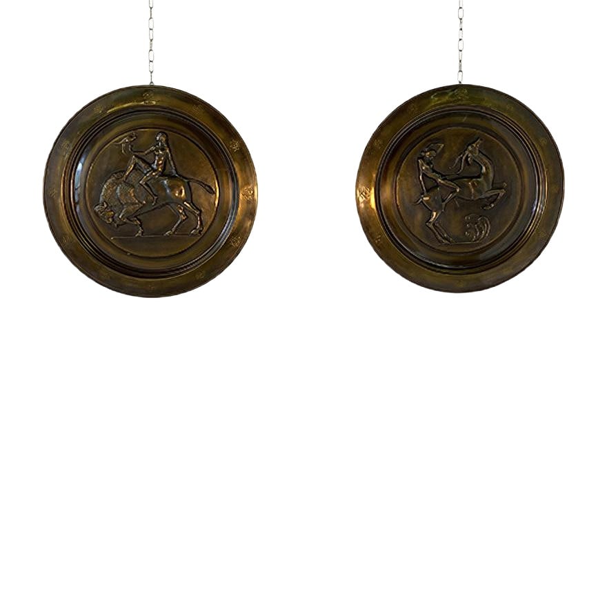 Art Deco Decorative Brass Plates, 1940s, Set of 2: Pair of hanging brass plates produced in Italy in the 1940s. The classic art deco subjects are represented and are in their original patina of the time.Small signs of wear due to age. Country of Manuf