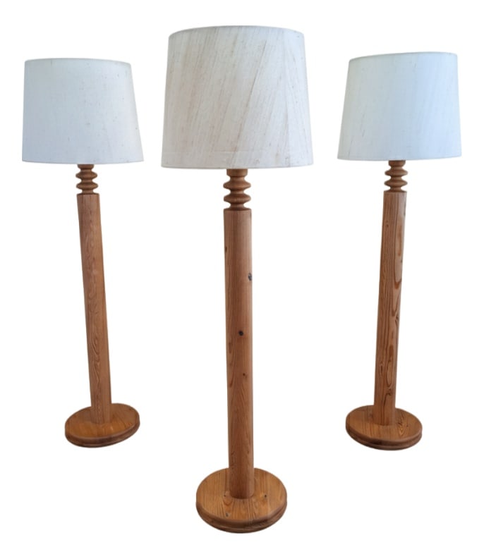 Pine Floor Lamps by Uno Kristiansson, Set of 3: This elegant set of three floor lamps was designed by Uno Kristiansson for Luxus in Sweden during the 1970s. Crafted from solid pine wood, the turned wooden detail beneath the shade adds a subtle