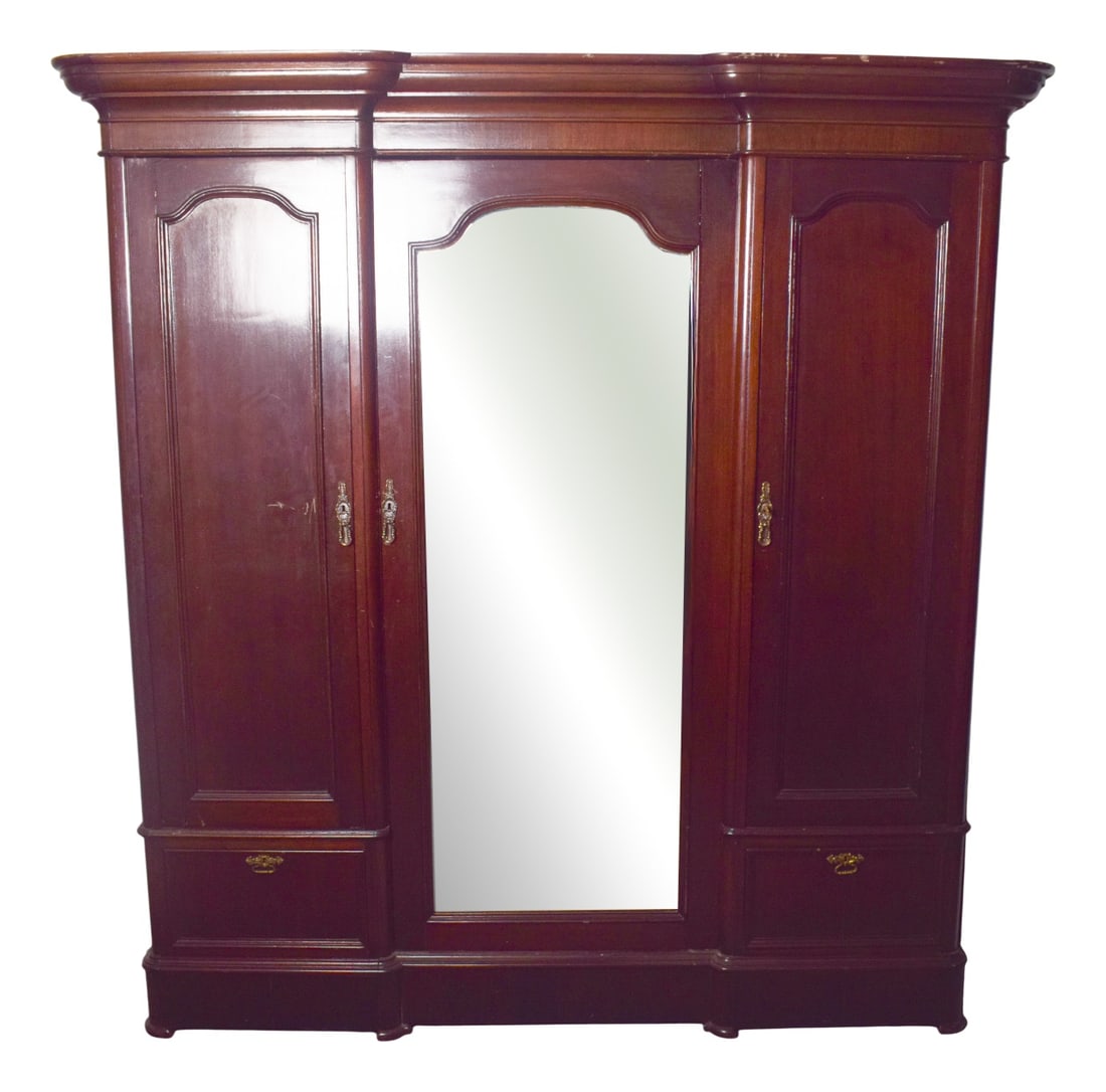 Antique English Mahogany Wardrobe with Central Mirror: This English Romantic wardrobe, crafted in rich mahogany, is a fine example of elegance and practicality combined. Its design features a large central door fitted with a tall mirror, flanked by two