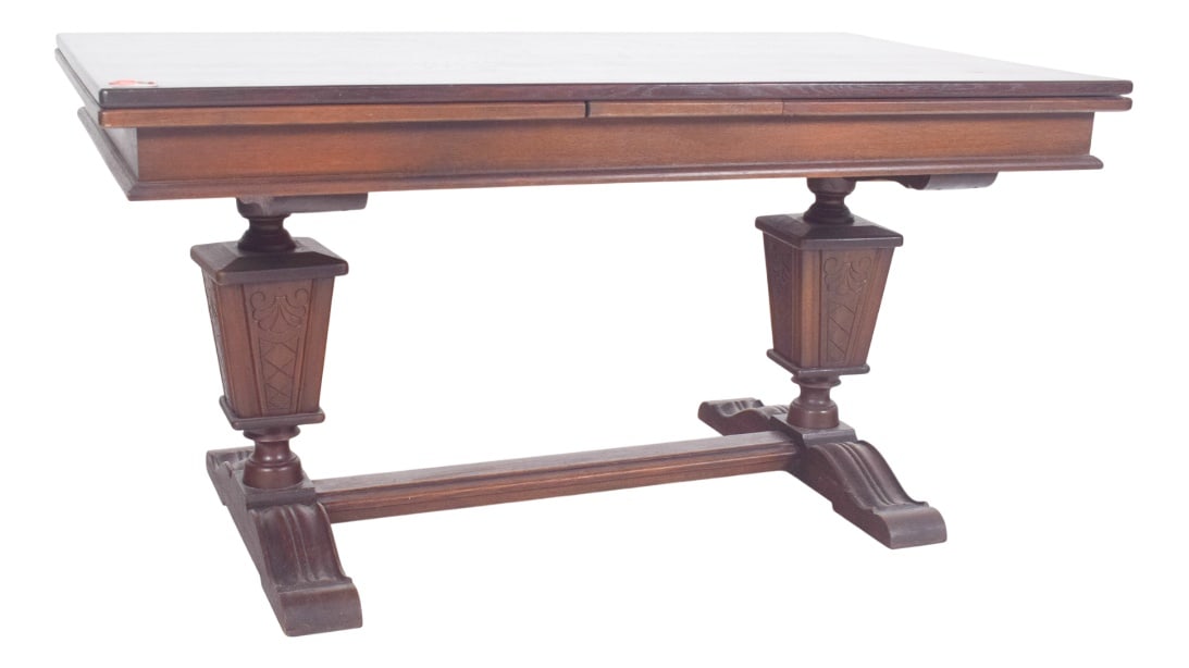 Portuguese Rectangular Extendable Dining Table, 1930: Rectangular extendable dining table. The top has straight edges with a stepped profile, showing a geometric design characteristic of the style. The support is made up of two central supports in the sh