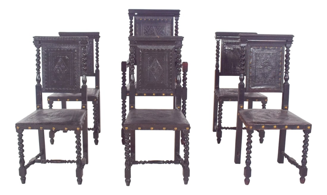Leather Dining Chairs, 1920s, Set of 6: Six dining chairs with leather and nailwork. 20th century Portuguese, in turned wood, carved and patinated in black. The work reveals a strong historicist influence, evoking the Baroque aesthetic by