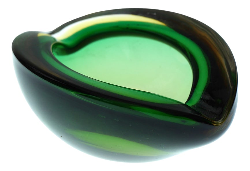 Mid-Century Modern Murano Glass Bowl, 1960s: An extraordinary and substantial handmade vintage glass bowl or centerpiece dish from Murano, Italy made during the 60s. This piece has a fantastic emerald green base, with a warm amber or deep