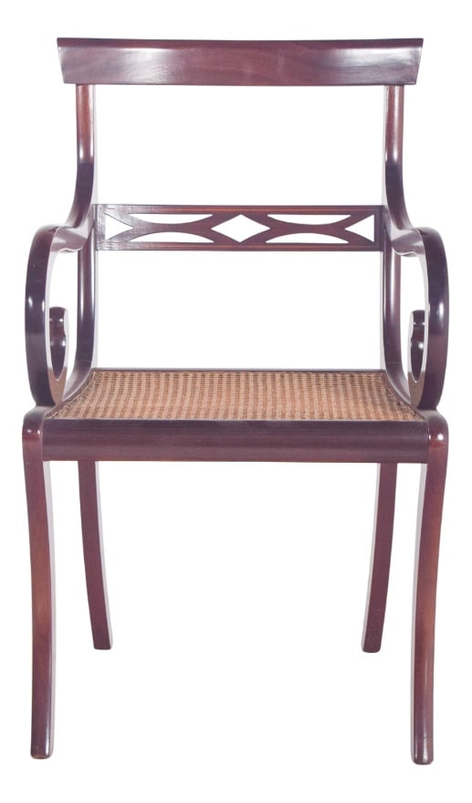 English Mahogany Armchair with Straw Seat, 1890s: Mahogany chair with straw seat. with curved legs, a slightly arched rear and a saber-shaped front, the arms, also curved, end in a decorative curl. The backrest is low, with a straight upper crossbar