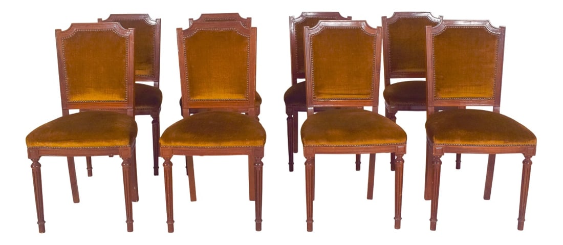 Portuguese Dining Chairs, 1950s, Set of 8: Set of eight dining chairs. In carved wood, with a neoclassical structure. The backs have an upper cut-out with a slightly arched profile, a protruding frame and geometric carvings, showing the