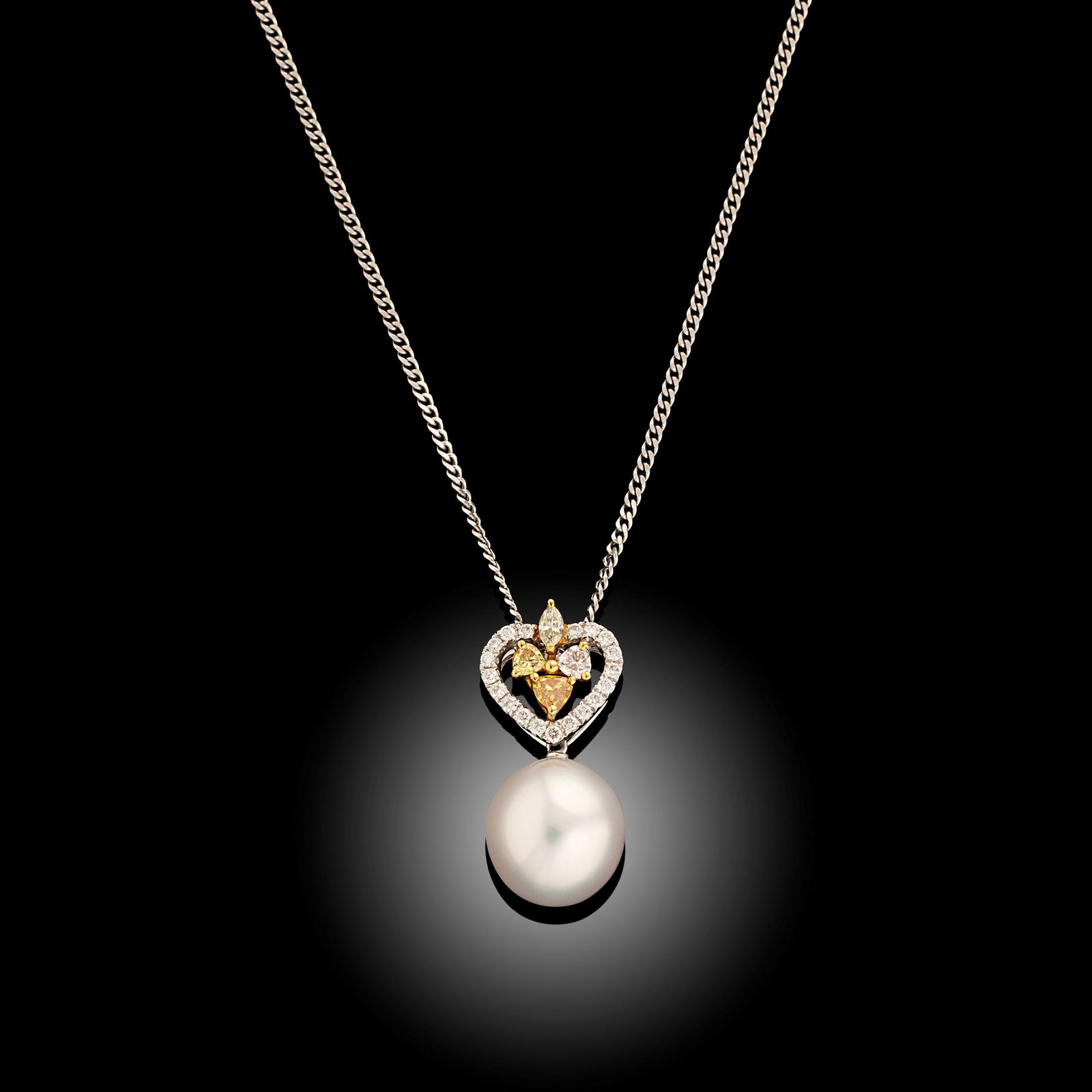 18 Carat South Sea Pearl And Fancy Colour Diamond Pendant: 18 carat white gold graduated Tahitian pearl pendant on chain Length 16" Metal Type 18ct White Gold Pearl Type South Sea Pearl Size 10.5-11mm Diamond Weight