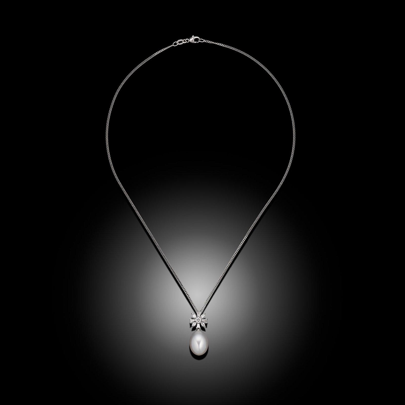 18ct White Gold Oval South Sea Pearl & Fancy Cut Diamond Pendant: 18ct white gold South Sea pearl pendant with baguette and marquise cut diamonds on curb chain Item Length: 16inch Drop Length: 25mm Metal Type: 18ct White Gold Pearl Type: South Sea Pearl Size: 11.5-1