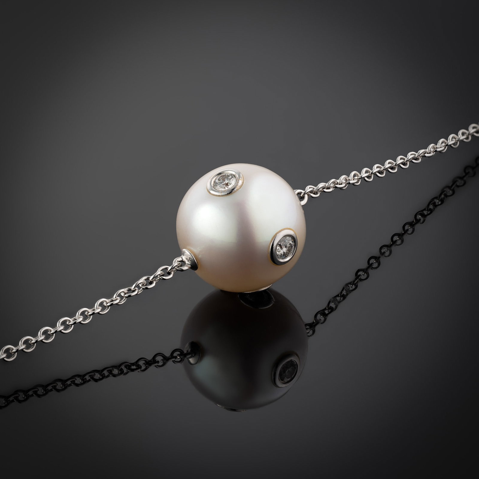 18 Carat Diamond Set South Sea Pearl Pendant Necklace: 18 carat white gold South Sea pearl pendant with embedded bezel-set diamonds Length 16" Metal Type: 18ct White Gold Pearl Type: South Sea Pearl Size: 13-13.5mm Diamond Weight: 0.22cts Condition: Unwor
