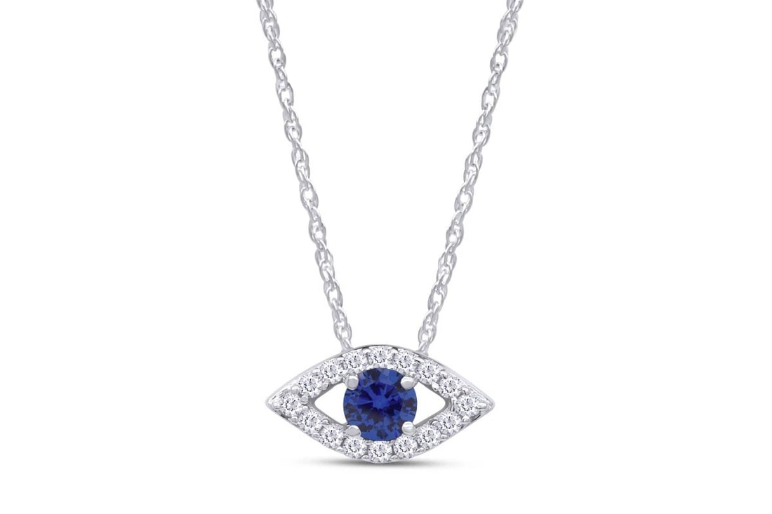 WHITE-METAL BLUE EVIL EYE PENDANT NECKLACE WITH COLORLESS ACCENTS: WHITE-METAL BLUE EVIL EYE PENDANT NECKLACE WITH COLORLESS ACCENTS Description: An eye-shaped pendant in polished white metal, centered by a deep-blue oval stone and bordered by small colorless