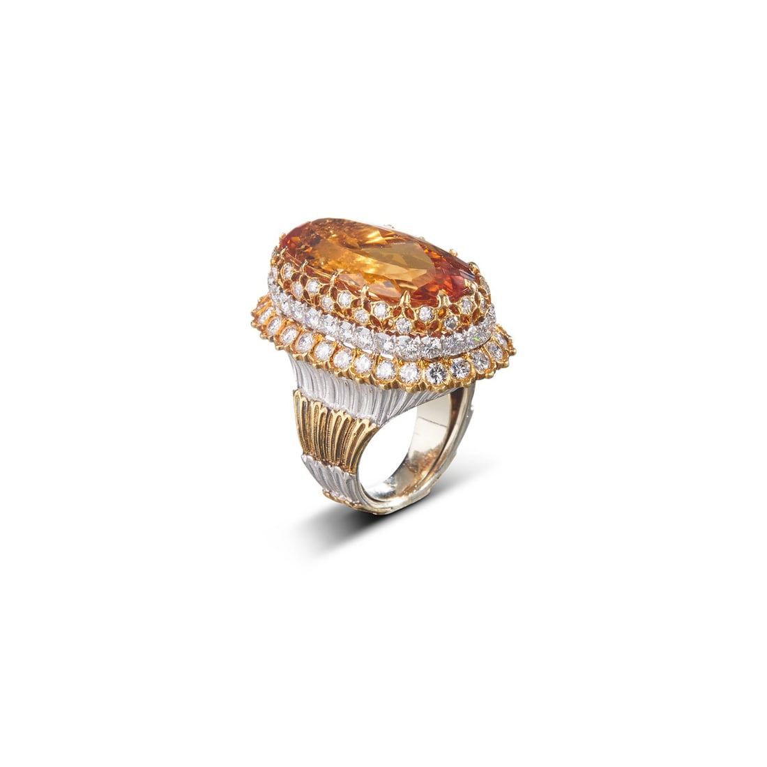 CITRINE AND DIAMOND COCKTAIL RING: CITRINE AND DIAMOND COCKTAIL RING Description: A cocktail ring centered by a large rectangular orange-yellow stone, bordered by rows of small white stones and ribbed shoulders. Multiple views show