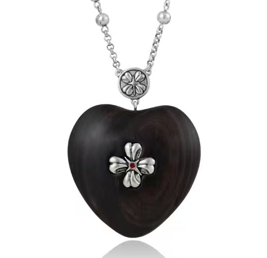 HEART-SHAPED PENDANT NECKLACE: HEART-SHAPED PENDANT NECKLACE Description: Heart-shaped pendant necklace featuring a dark polished heart-form body suspended from a silver-tone chain. The pendant is centered with a raised four-petal