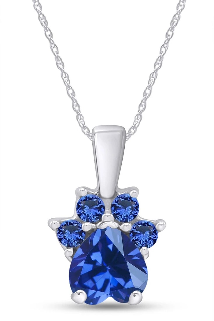 WHITE-METAL DEEP-BLUE AND COLORLESS STONE CLUSTER PENDANT NECKLACE: WHITE-METAL DEEP-BLUE AND COLORLESS STONE CLUSTER PENDANT NECKLACE Description: A compact pendant centered by a large deep-blue faceted stone and surrounded by smaller blue and colorless accents,