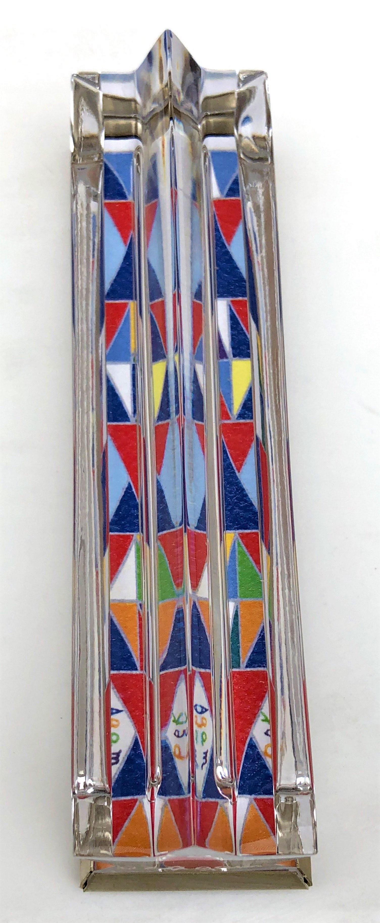 Yaacov Agam, Israeli (Born 1928): Decorative mezuzah designed by Yaacov Agam and in collaboration with the famous glass factory Daum in France integrating glass silver on an acrylic base. Height 12 cm, width 3 cm, engraved signature