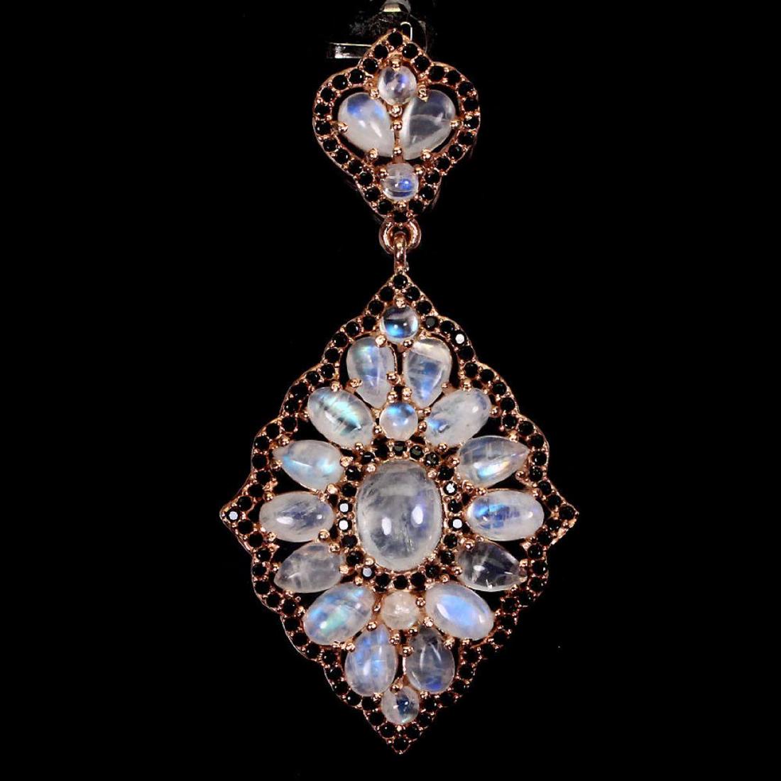 Natural Top Luster Moonstone Black Spinel Pendant: 925 STERLING SILVER;PLATE14K ROSE GOLD;MAIN STONEMOONSTONE;OTHER GEMSBLACK SPINEL;TOTAL WEIGHT37.25 CT (TOTAL WEIGHT OF SILVER + STONE)DIMENSION* STONE 1.0 TO 9.0 X 7.0 MM. * FACE PENDANT 58.0 X 29.0