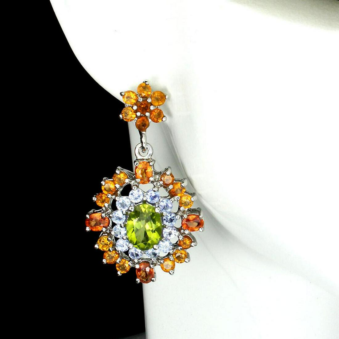 Natural Peridot Sapphire Tanzanite Earrings: 925 STERLING SILVER; PLATE- 14K WHITE GOLD; MAIN STONE- PERIDOT; OTHER GEMS- SAPPHIRE, TANZANITE; TOTAL WEIGHT- 11.2 GRAM (TOTAL WEIGHT OF SILVER + STONE) DIMENSION- * STONE 2.5 TO 8.0 X 6.0 MM.; * FA