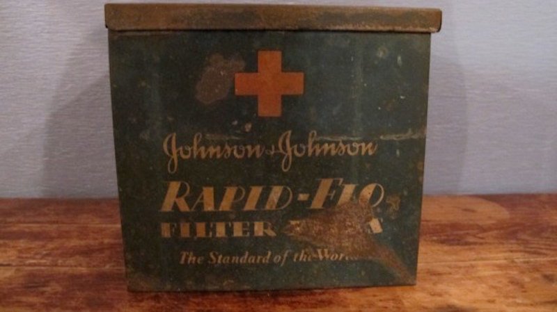 206. Vintage " Rapid-Flo" Tin Dairy Farm Box: Vintage Johnson & Johnson Rapid Flo Filter Tin with hinged lid. This is an old farm dispenser box for dairy farm milking cows. Dimensions: 8"w x 8"d x 7"h.