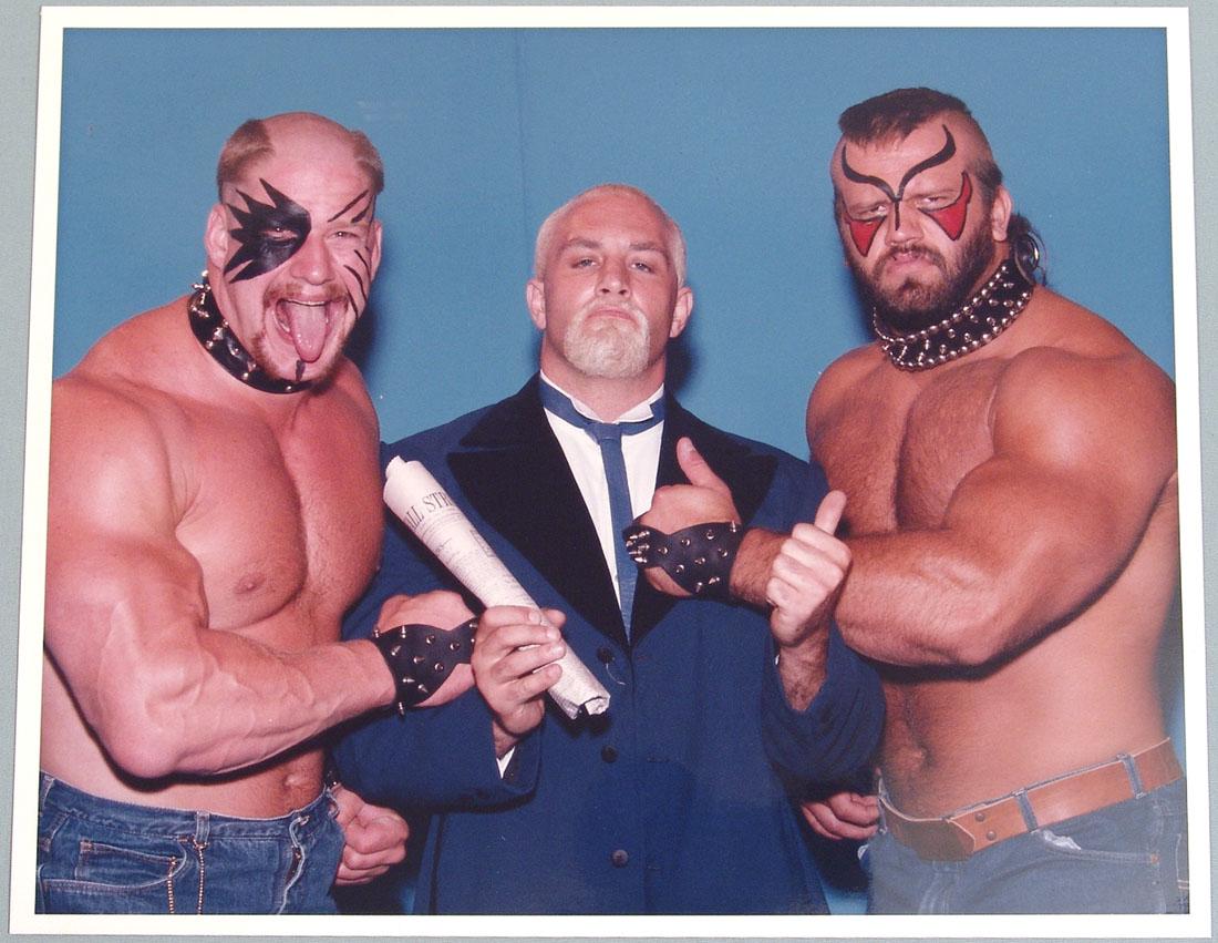 c1980s Wrestling Promo Photograph - "The Road Warriors": This is a vintage circa 1980s wrestling promo photo of "The Road Warriors", Hawk (Michael Hegstrand) and Animal (Joseph Laurinaitis), with Precious Paul Ellering. 10" x 8".