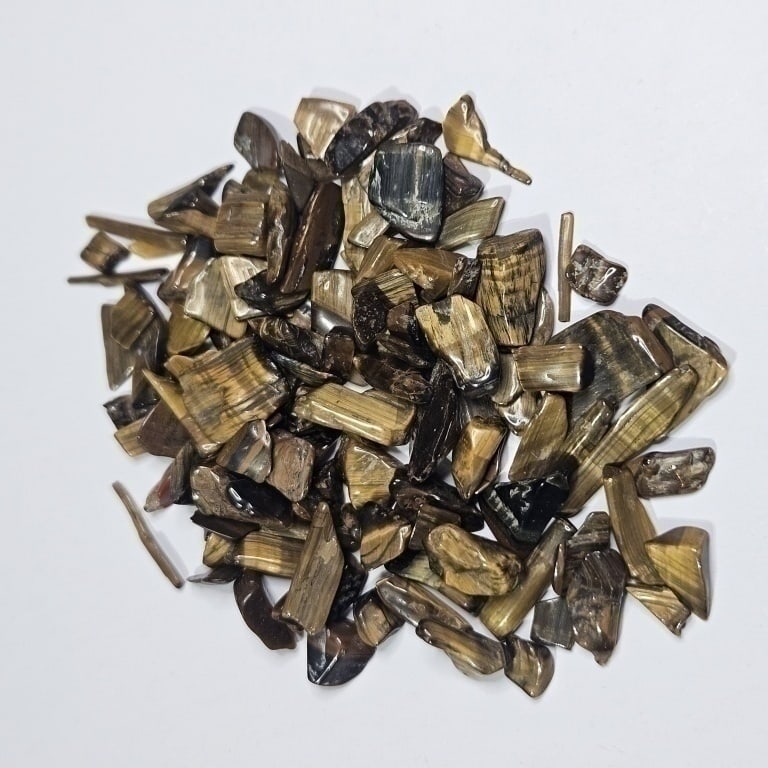 88.4 tcw Natural Tiger Eye Tumbled Chips: Item is the exact item in the image - Bidder is responsible for all value and grade determination - 17.68 grams