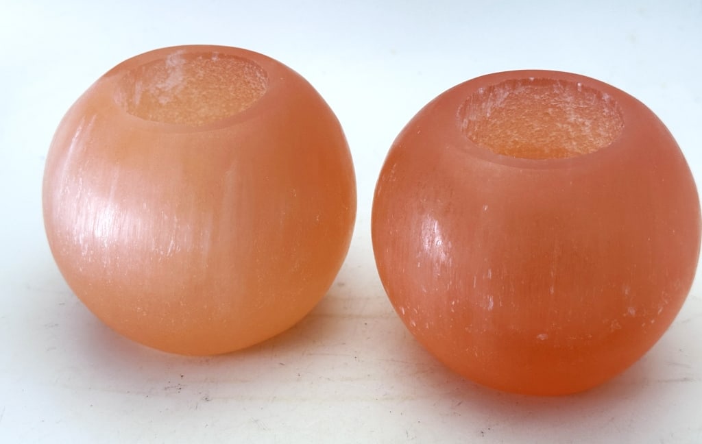 Pair of Orange Selenite Candle Holders: Orange selenite is a beautiful gypsum stone that contains some levels of hematite and quartz that is said to bring happiness and pleasure.