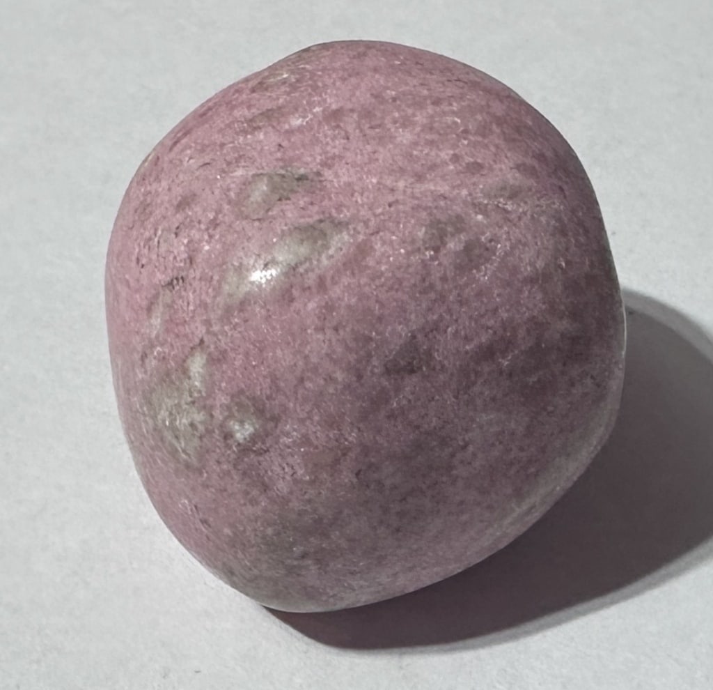 30.7 gram Thulite Tumbled Stone: Item is the exact item in image - Bidder is responsible for all value and grade dtermination - Please review all terms and conditions