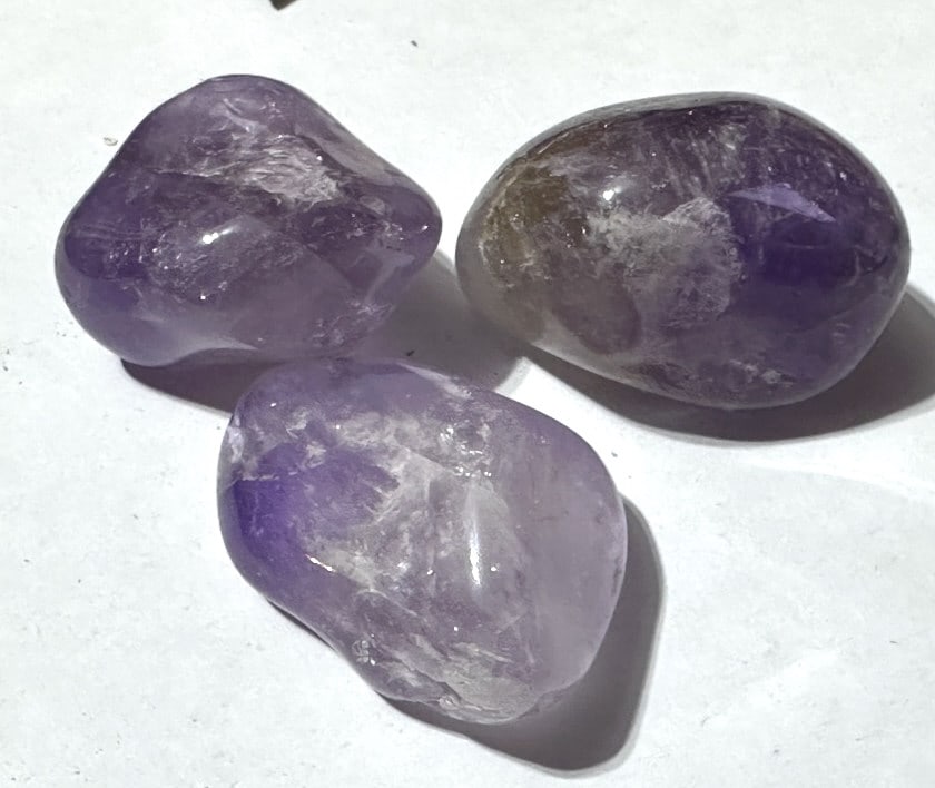 Lot of (3) Natural Tumbled Amethyst Stones: Items are the exact items in the image - Please review the entire terms and conditions prior to placing any bids - Any bid is an agreement to all terms and conditions -