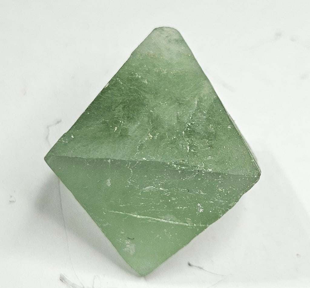 26.75 gram - Green Flourite Octahedron Specimen: Item is approx. the size of a half dollar - Item is the exact item in the image - Bidder is responsible for all value and grade determination -
