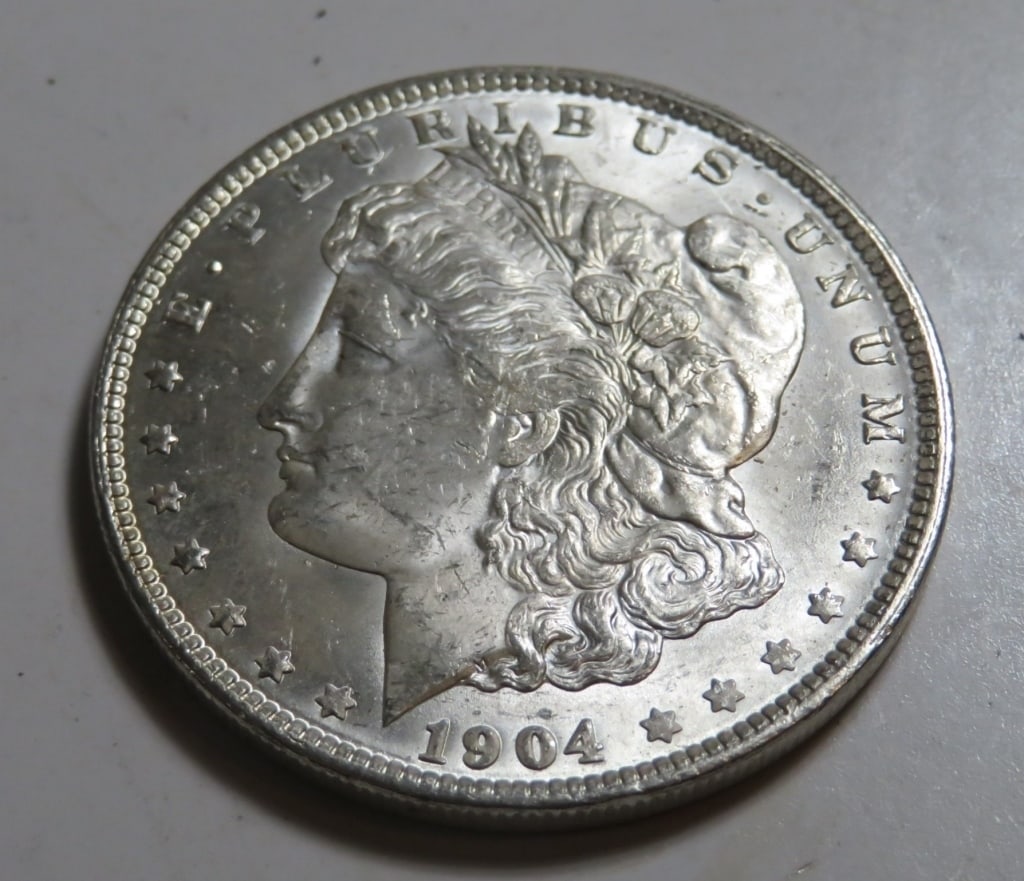 1904 O BU Grade Morgan Silver Dollar: Item is as shown in image - Exact grade and date as detailed in title and in images. Bidder is responsible for all value and all bids are subject to all terms and conditions agreed to in terms.
