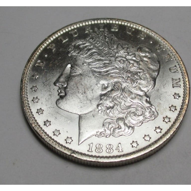 1884 O BU Grade Morgan Dollar: Type will be our choice and from on hand at time of sale. Item is the EXACT ITEM in the image. Bidder is responsible for all value and determination of value. The images are high resolution andtheEXAC