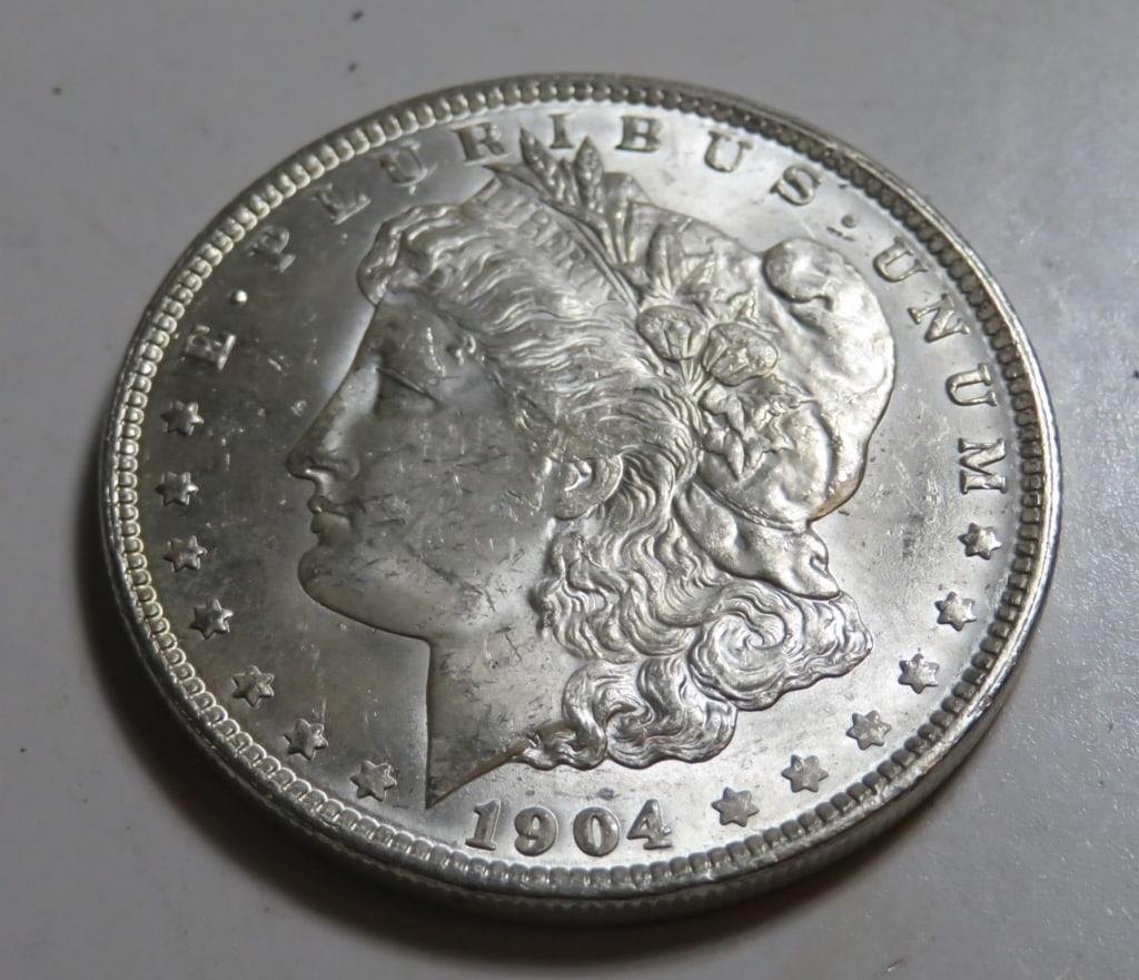 1904 O BU Grade Morgan Silver Dollar: Item is as shown in image - Exact grade and date as detailed in title and in images. Bidder is responsible for all value and all bids are subject to all terms and conditions agreed to in terms.
