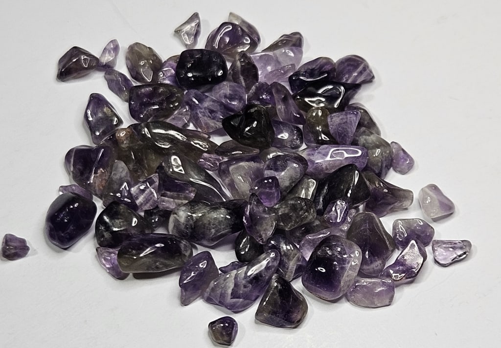 105.65 tcw. Natural Amethyst Tumbled Chips: Items are as described in the tile - Please use the image to verify the item - Please review the entire terms and conditions prior to placing any bids- All sales final -