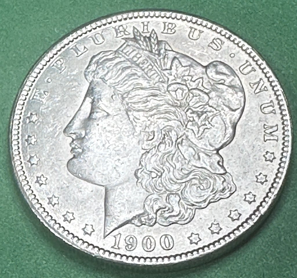 1900 O Au Plus Morgan Silver Dollar: Item is as shown in the image - Bidder is responsible for all grade and value determination - Please review the entire terms and conditions prior to placing any bids - All sales final
