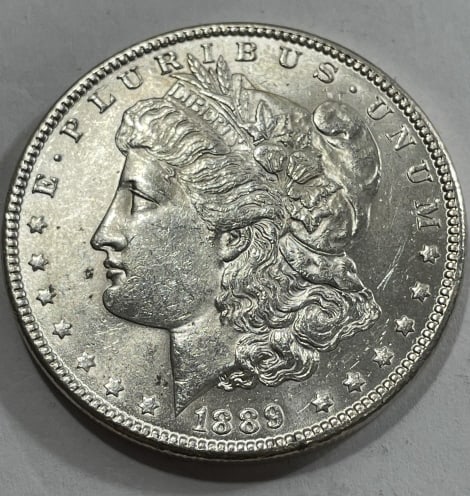 1889 BU Grade Morgan Silver Dollar: Item is the item in the image. Bidder must determine grade and value by your bid amount. Please refer to all the terms set forth in this auction.