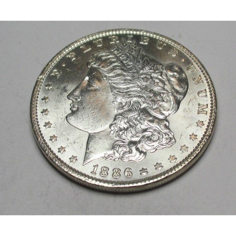 1886 P BU Grade Morgan Dollar: Type will be our choice and from on hand at time of sale. Item is the EXACT ITEM in the image. Bidder is responsible for all value and determination of value. The images are high resolution andtheEXAC