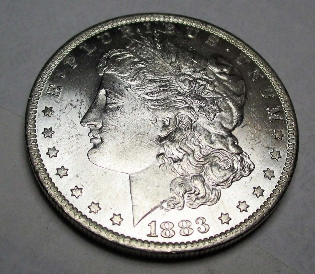 1883 O BU Morgan Silver Dollar: Items are as shown in image. Bidder is responsible for all grade and value. Please review all terms and understand shipping procedure prior to bidding.