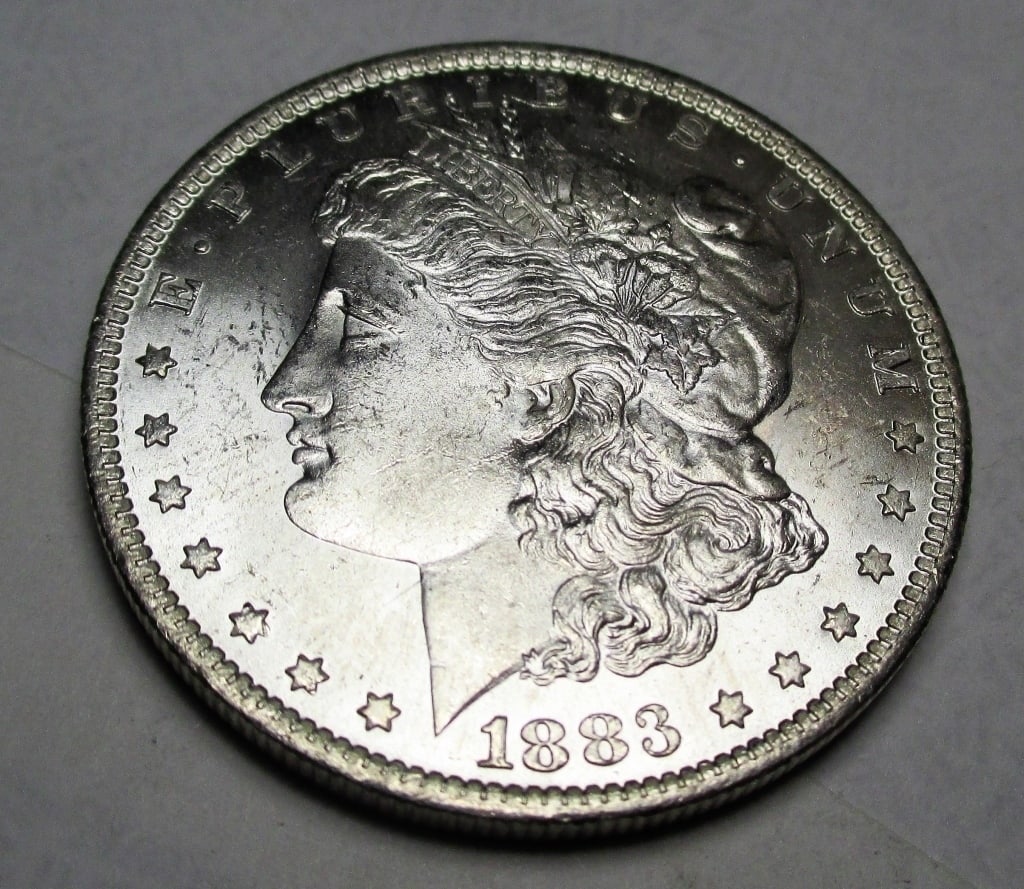 1883 O BU Morgan Silver Dollar: Items are as shown in image. Bidder is responsible for all grade and value. Please review all terms and understand shipping procedure prior to bidding.
