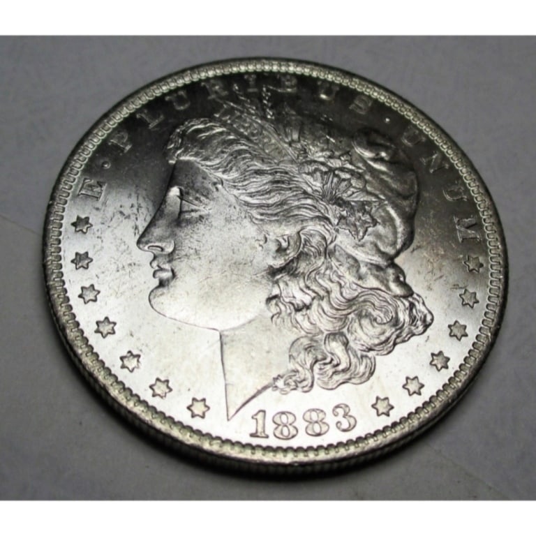 1883 O BU Morgan Silver Dollar: Items are as shown in image. Bidder is responsible for all grade and value. Please review all terms and understand shipping procedure prior to bidding.