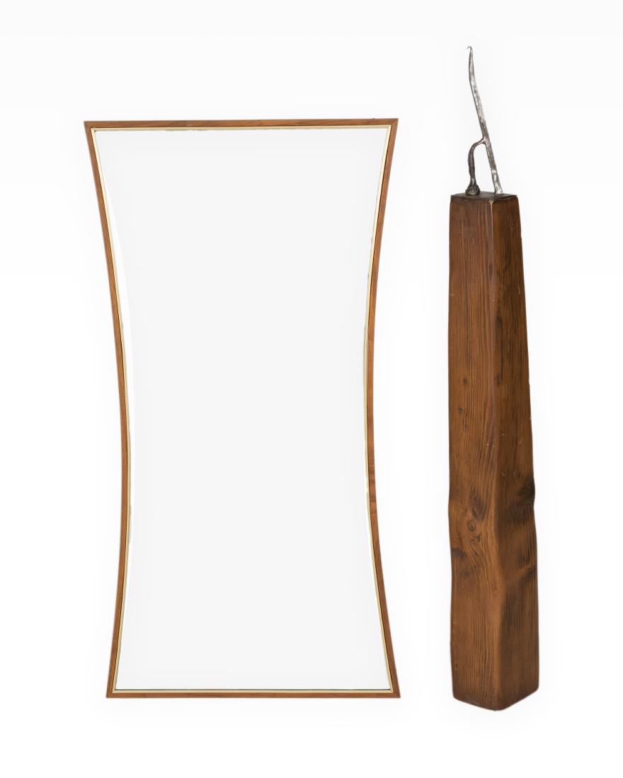 Teak and Brass Mirror and Iron Sculpture: Description - An hourglass teak and brass mirror and an iron sculpture on a wooden plinth. Dimensions - Mirror - 50" x 25"
