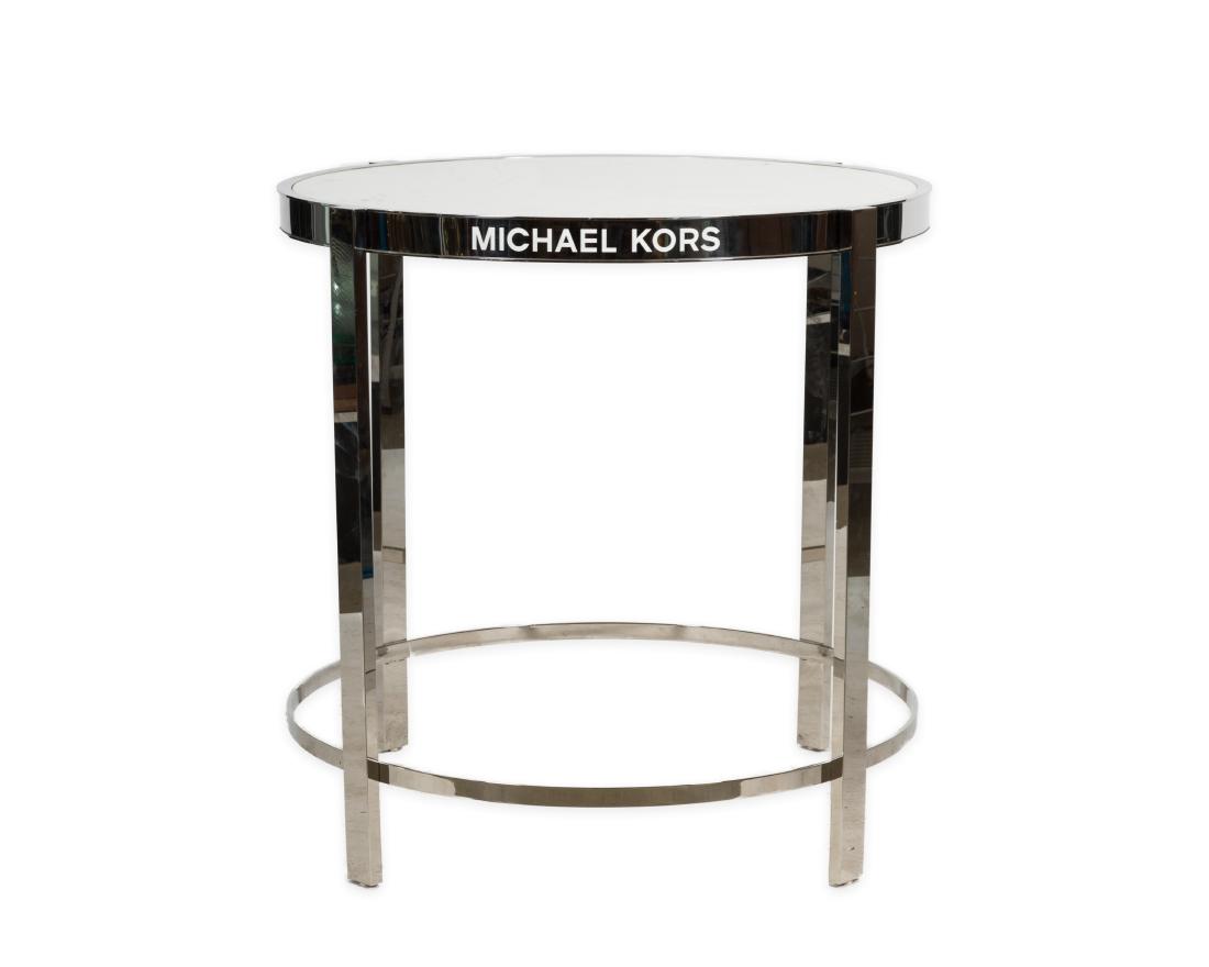 Michael Kors Chrome Display Table: Description - A Michael Kors chrome display table. Dimensions - 32" x 33.5"