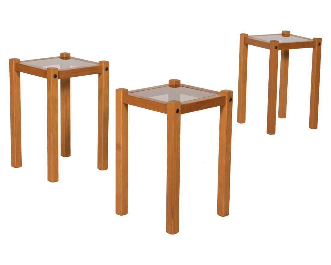 Three Teak and Smoked Glass Tables: Description - A set of three teak and smoked glass tables. Dimensions - 17" x 11"