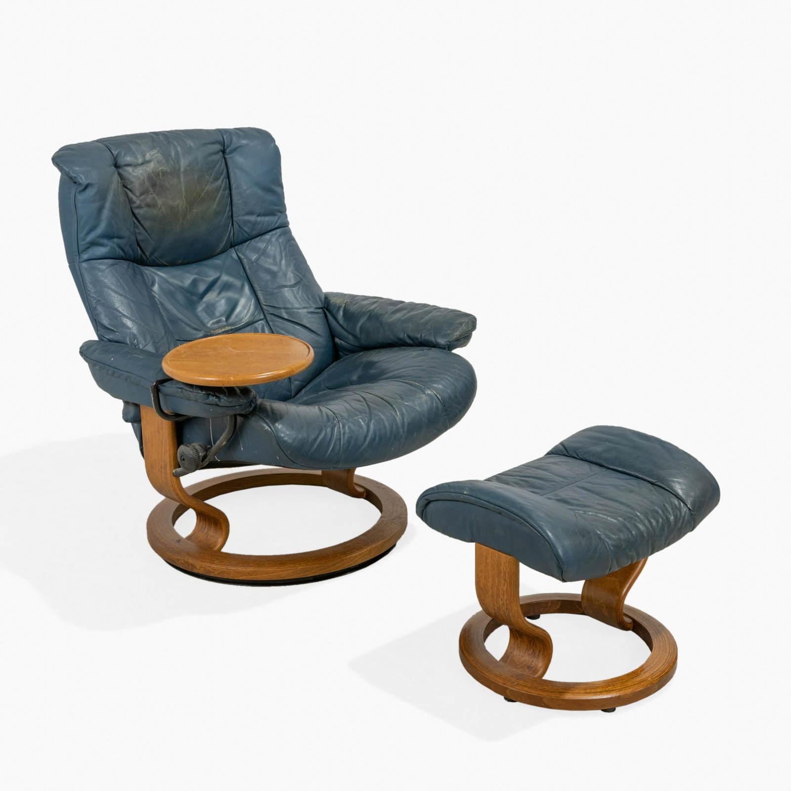 Ekornes Stressless Chair & Ottoman: A blue leather chair and ottoman by Ekornes. With attached table. Chair - 39" x 30" x 34"